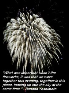 Dark night sky with bright white fireworks.